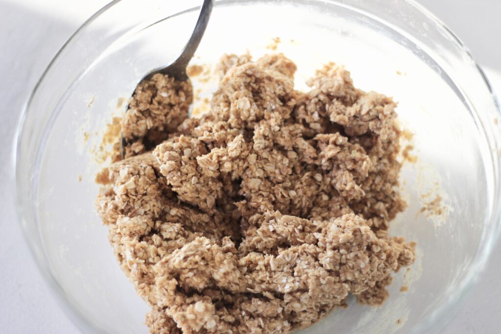 Oatmeal peanut butter ball ingredients being mixed together 