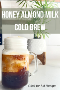 Glass mason jar of honey almond milk cold brew coffee