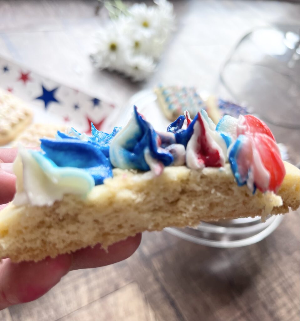 Decorated frosted sugar cookie with a bite taken